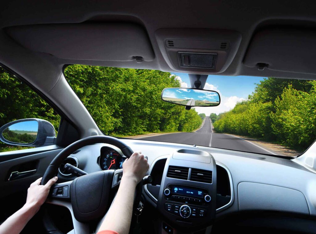 Driver looking through a windshield of their car